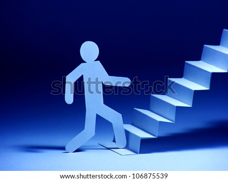 Paper man walking up on stairs
