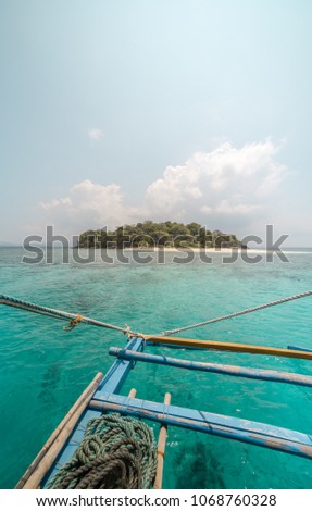 Paradise desert island in Palawan, Philippines. Picture taken from simple boat. Great ocean colors
