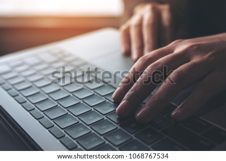 Closeup image of business woman working and typing on laptop keyboard 