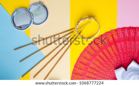Fan red Chinese or Japanese made paper background and space for text or symbol mirror and bracelet