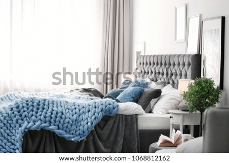 Modern room interior with comfortable bed