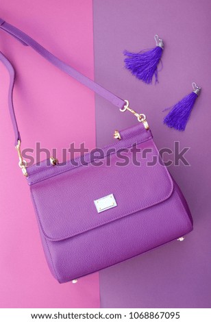 Purple shoulder bag, purple earrings, purple purple background	
 Royalty-Free Stock Photo #1068867095