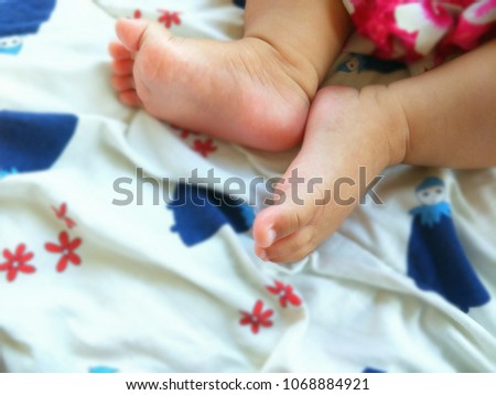 Focus on part of little legs baby is sleeping and blurred baby sleeping bag background for so softly and interesting image 
