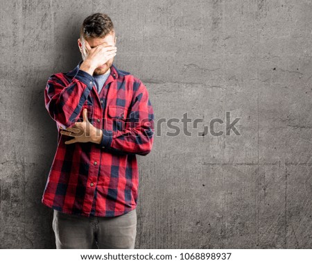 Young handsome man stressful keeping hands on head, tired and frustrated