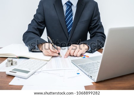 Male businessman calculating table data