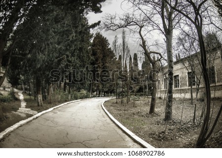 Abandoned village house building in Baku Botanical garden. Nobody in the park with trees. Springtime. Selective focus