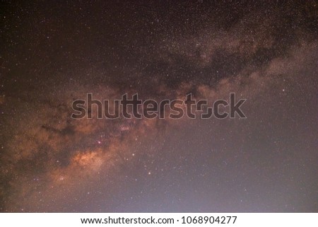 In the night sky there is the Milky Way and the stars shine in the dark and vast sky.
