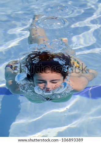 teenager is swimming underwater