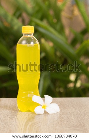 Glass and yellow drink on a table on a green background