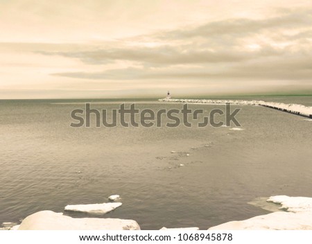 Lighthouse in distance. Lake Superior, Marquette, MI. Artistic. Winter.