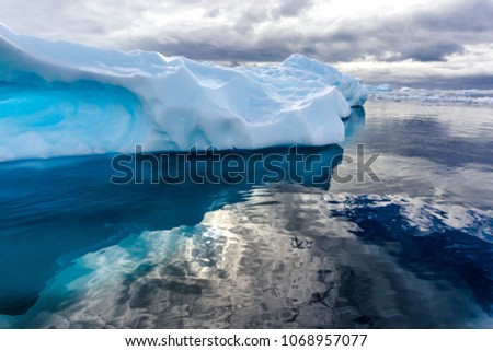 Semi-cloudy day covers iceberg in Neko Bay