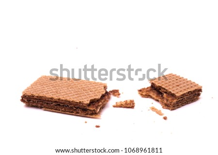 Wafer biscuit with chocolate cream isolated, broken piece on white background