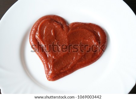 Ketchup in the form of a heart on dinner plate. Royalty-Free Stock Photo #1069003442