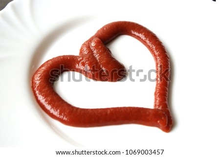 Ketchup in the form of a heart on dinner plate. Royalty-Free Stock Photo #1069003457