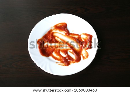Dirty dish  with tomato sauce. Royalty-Free Stock Photo #1069003463