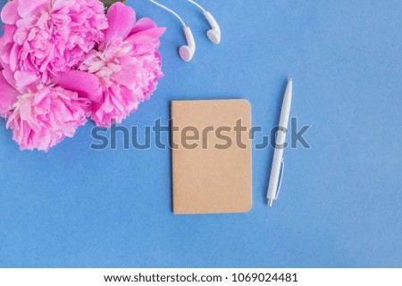 Mockup notebook with pink peonies on a blue background