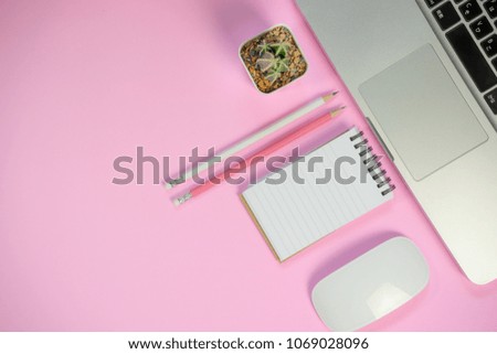 Flat lay style picture of workspace with office supplies on pink pastel coloured background. top view with copy space.