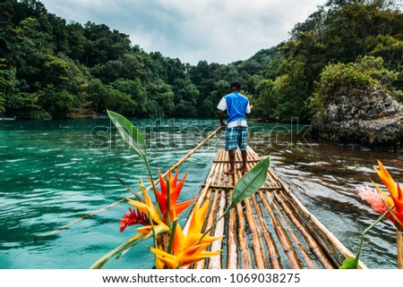  Bamboo ride in blue lagoon on Jamaica Royalty-Free Stock Photo #1069038275