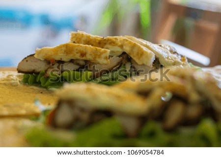 Making of meat, egg and cheese tortilla wrap. Fresh vegetables. 