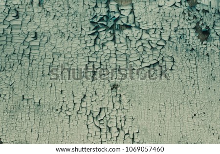 wooden board with cracked green paint as background