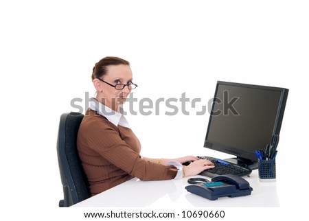 Attractive middle aged businesswoman working in office on computer,  white background,  studio shot.
