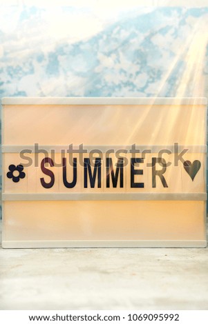 Summer letter on the led board on table. Concept of summer tourism, travel and vacation