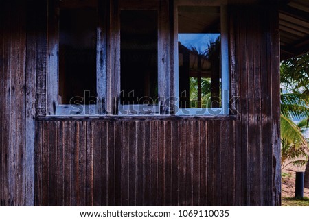 Aged weathered wooden window in the old home.