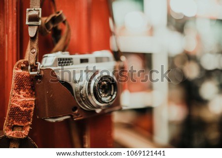 Old, vintage cameras hanging on the wall. Photography concept. Horizontal image with free space for your text, other cameras in the background. Indoor shot with selective focus.