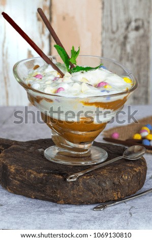 White chocolate ice cream and caramel dessert garnished with chocolate eggs and fresh mint