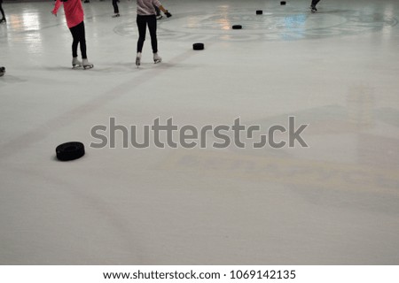 People skate on the ice hockey arena