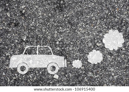 Symbol of a polluting car painted on the surface of an asphalt road.