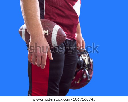Closeup Portrait of a strong muscular American Football Player isolated on colorful background