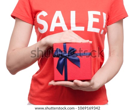 Woman with t-shirt with an inscription sale in hand box shop buy discount on a white background isolation