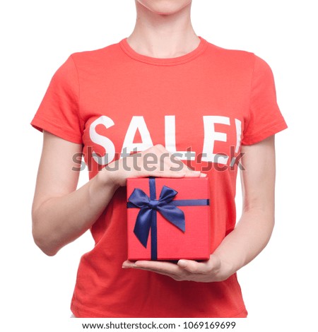 Woman with t-shirt with an inscription sale in hand box shop buy discount on a white background isolation