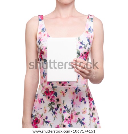 Woman in a dress floral print in the hands white sign on a white background isolation