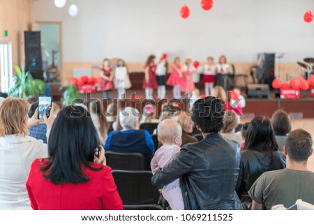 parents are watching the performance children in kindergarten