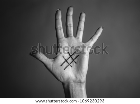 Black hashtag marked on girl's tender pale palm of hand. Close-up. Concept (idea) of the Internet, social media, networking, communication, internet addiction.
