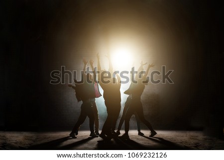 young people standing around with raised hands. praying together to the sun.influence of sect. worship light. worship the Sun. Sun cult. dancing movies Royalty-Free Stock Photo #1069232126