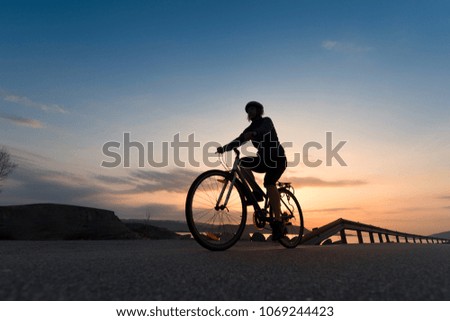 Low angle view of cyclist in the sunrise.Sport and active life concept in the summer time.
