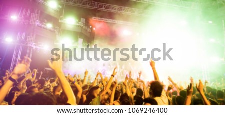 Blurred people dancing and having fun in summer festival party outdoor - Crowd with hands up celebrating fest concert event - Defocused image - Youth,fest,event,music, and entertainment concept