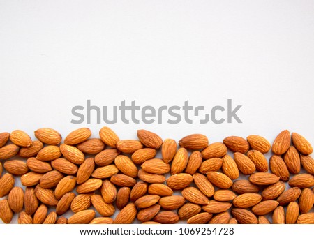Raw Natural Organic Almonds Nuts Scattered Isolated on Grey Background Top View Healthy Food for Life Natural Light Selective Focus