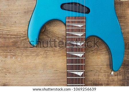 electric guitar parts on stylish wooden top. Copyspace for desig