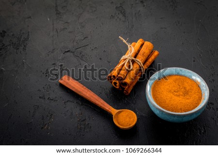Cinnamon seasoning. Sticks and powder on black background copy space