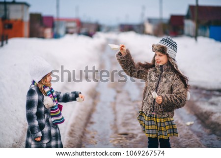 Little girls playing on the street in the village.