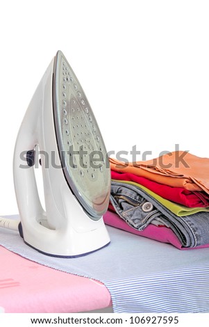 iron on ironing board with clothes