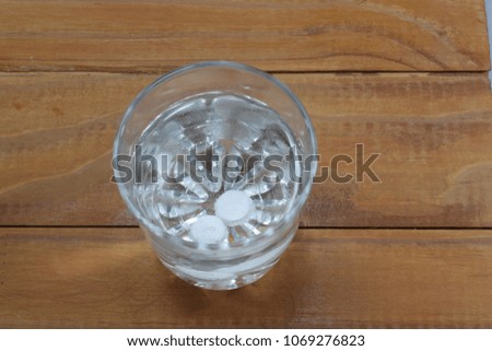 two tablets in a glass of water dissolve
