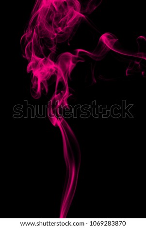 Smoke the pink incense on a black background. darkness concept