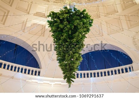 Christmas tree hanging upside down on the ceiling Royalty-Free Stock Photo #1069291637