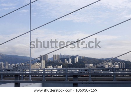 Abstract architecture. High-rise buildings of modern city viewed from cable-stayed bridge.