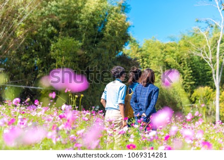 Young Asian tourists taking a photos in Fields of Cosmos.Travel concept .
